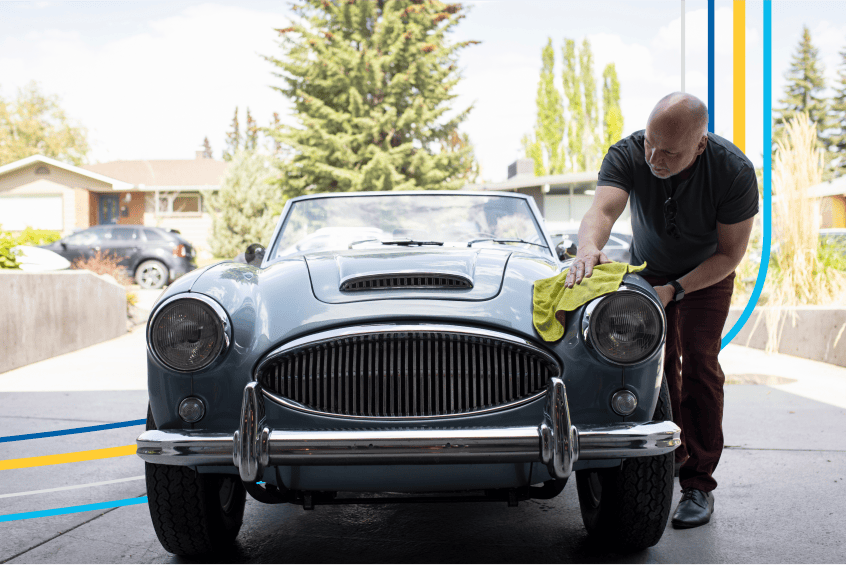 image of a man polishing his collector car in his garage
