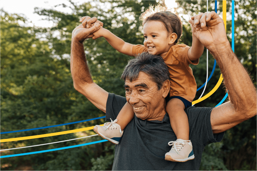 Image of a father with his daughter on his shoulders