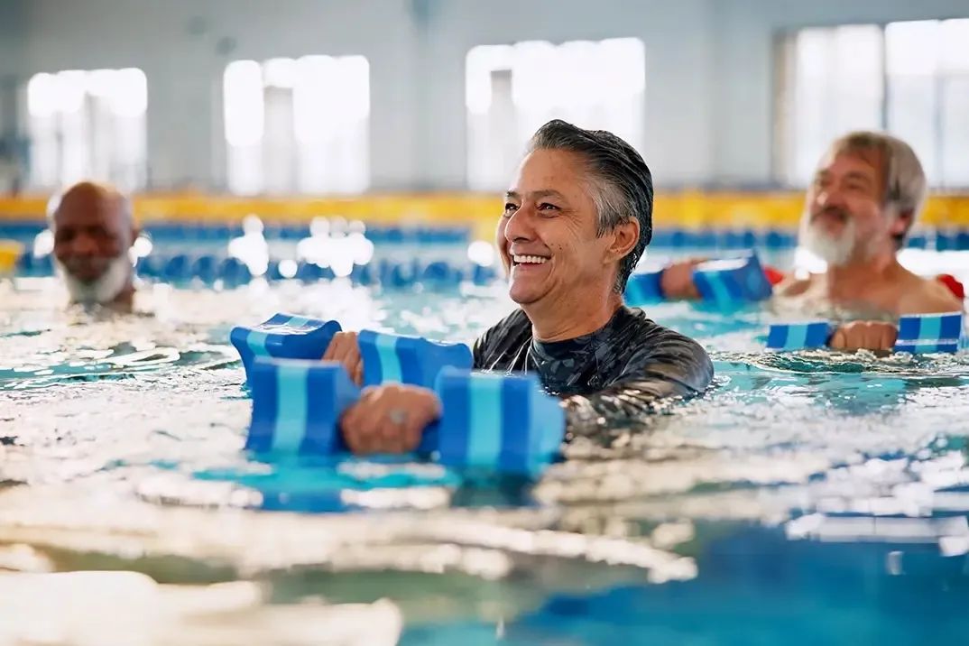 A senior man is smiling and looking off into the distance during his swim lesson, now that he is protected by Life Insurance.