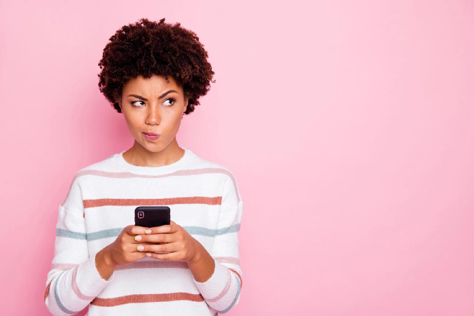 Woman on her phone, thinking about health insurance options