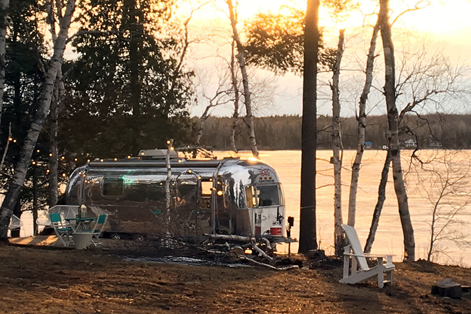 An RV beside a lake.