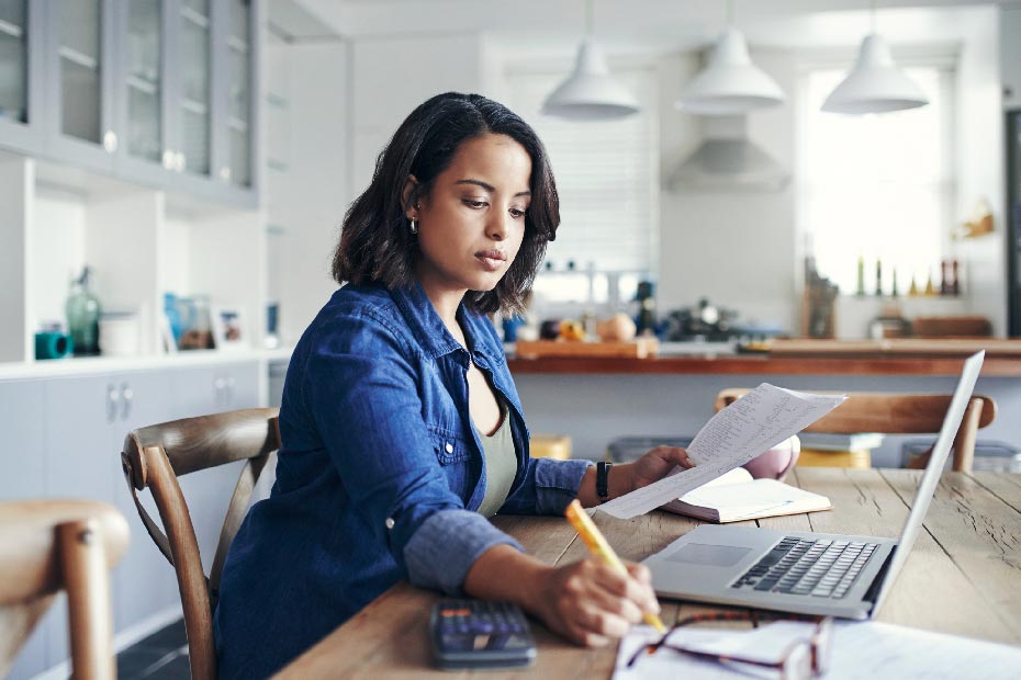 woman doing paperwork at table