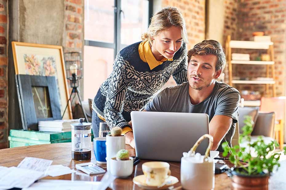 A man and a woman looking at laptop screen.