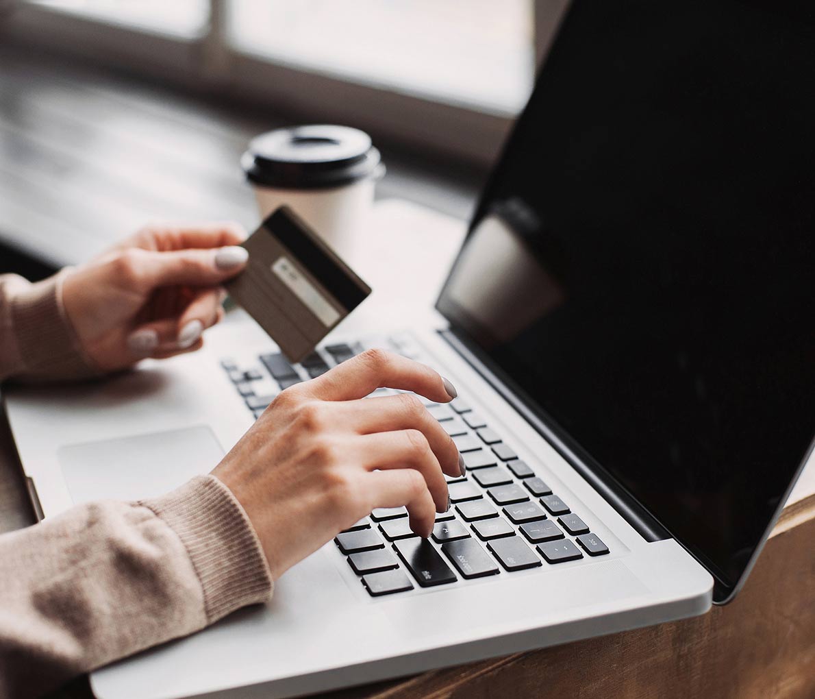 Hands typing back of the credit card number on the keyboard