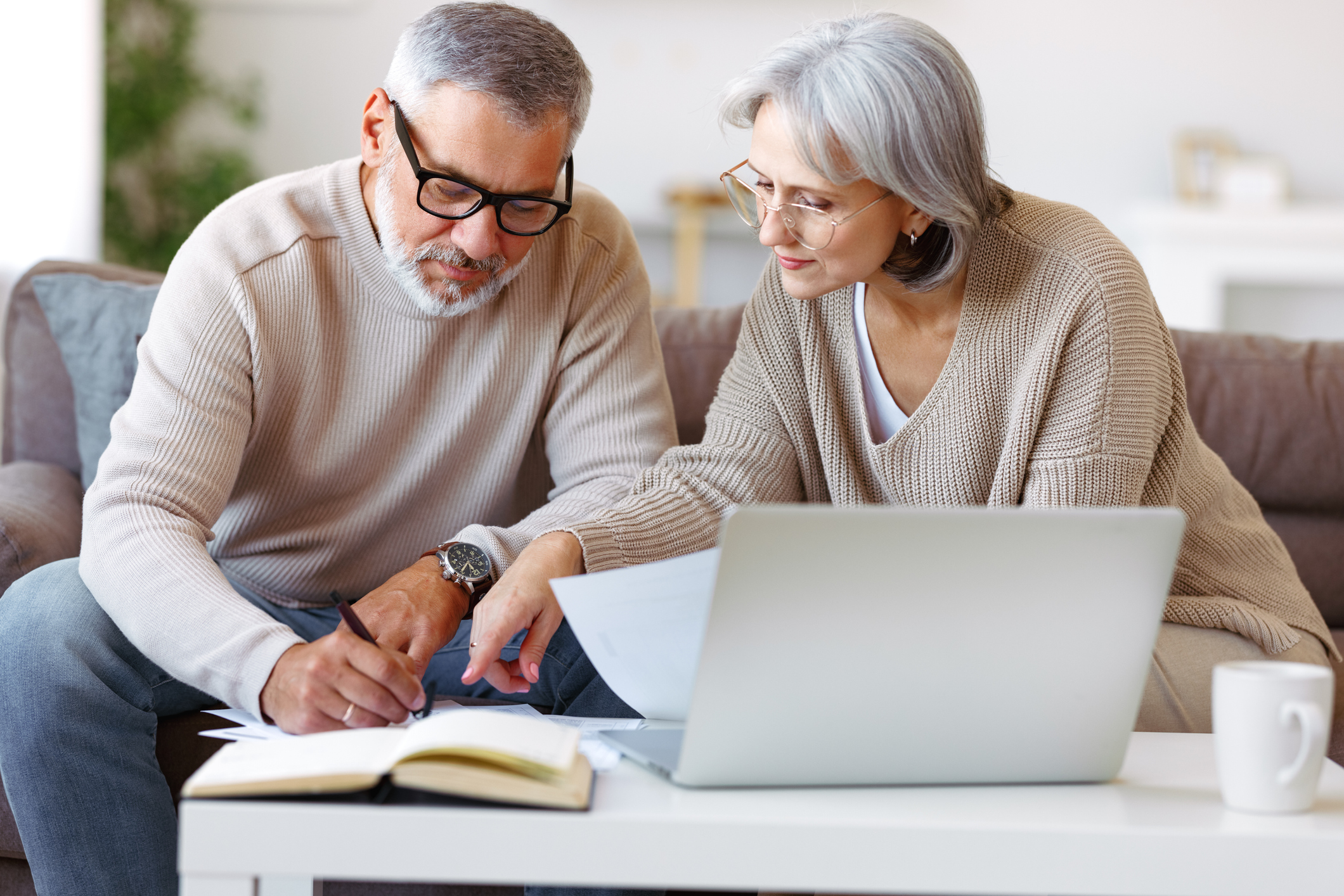 An older couple looking at their notes