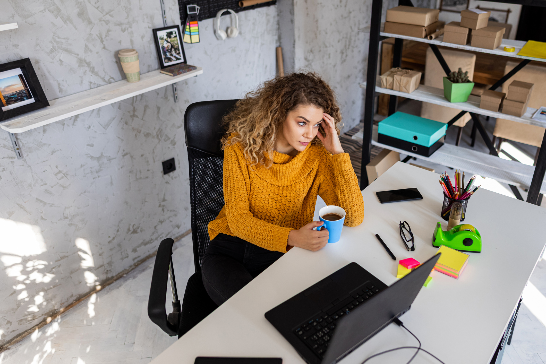 A thoughtful woman working from home