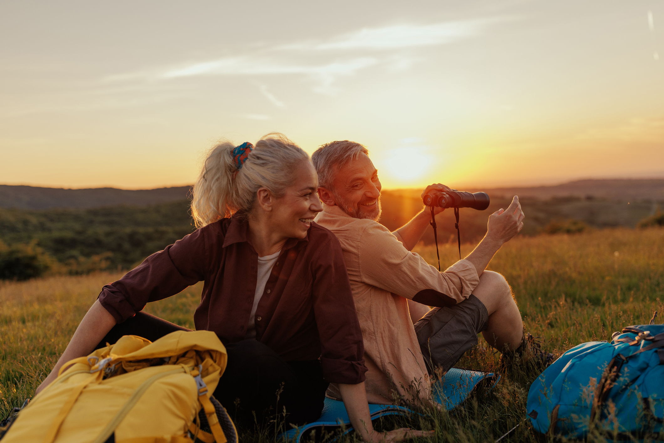 Mid-adult hiker couple resting after walking