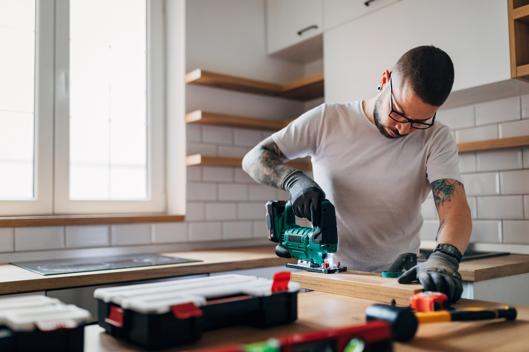 A carpenter is working in the kitchen