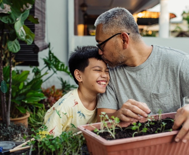 image of a father kissing his son on the head